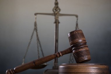 Ahşap masa arkasında hukukun ve adaletin sembolleri. Yargıç ofisi.