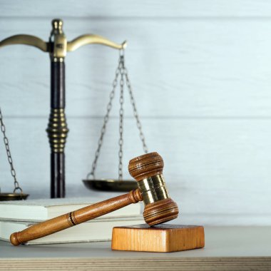 Yakın plan görüş, hukukun sembolleri ve ahşap masa arkasında adalet.