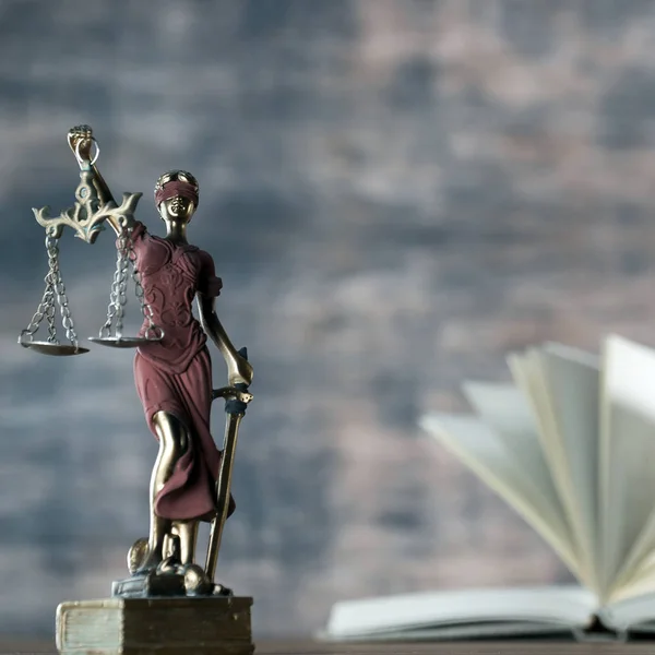closeup view of Themis sculpture with scale on table, jurisprudence concept