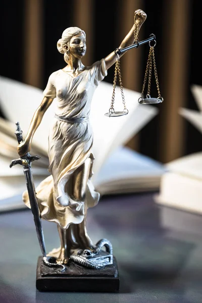 closeup view of Themis sculpture with scale on table, jurisprudence concept