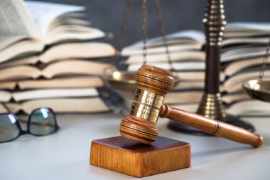 Hukuk ve adalet kavramı, tahta tokmak ve masada kitaplar.