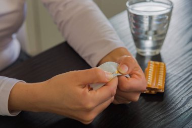 Büyük tek kırmızı hapı tutan kadın.