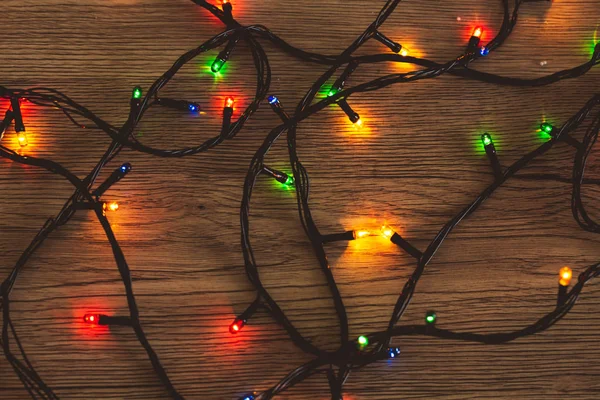 Garland colorful lights on wooden background