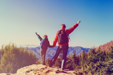 Manzaralı dağlarda mutlu bir aile yürüyüşü