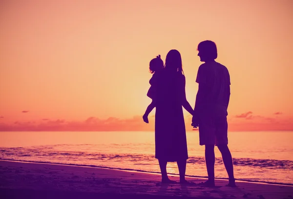 Happy family with little daughter together at sunset — Stock Photo, Image