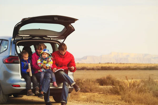 family with two kids travel by car in mountains