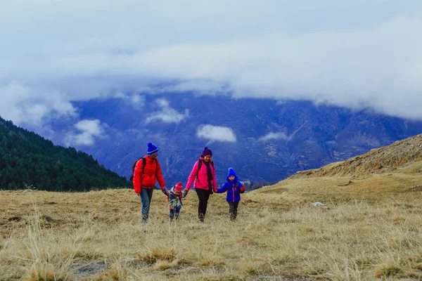 冬山中徒步旅行的两个小孩的家庭 — 图库照片