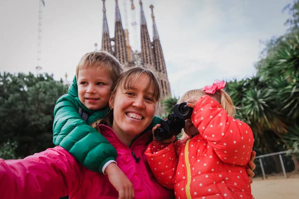 Family tourism - mother with kids travel in Barcelona