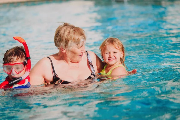 grandmother with kids swimming together