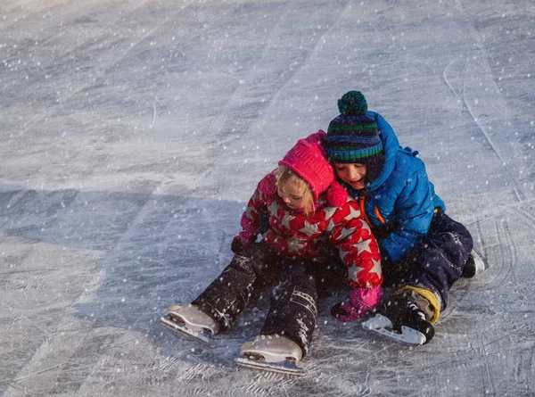 Gelukkig weinig jongen en meisje samen schaatsen — Stockfoto