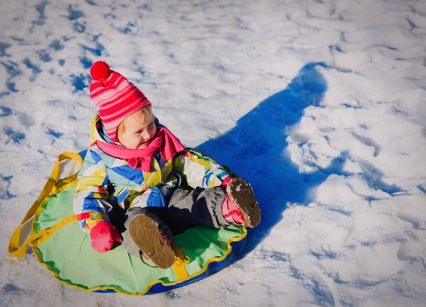 Happy little girl enjoy snow ride, winter kids — Stock Photo, Image