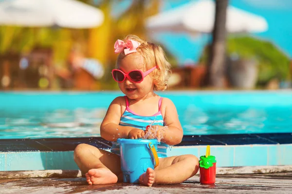 Cute little girl playing on tropical beach Stock Photo