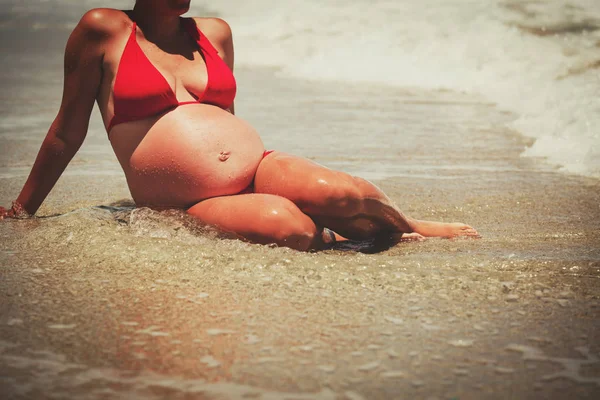 Mulher grávida relaxar na praia — Fotografia de Stock