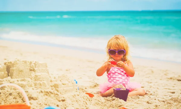 Милая маленькая девочка играет на летнем пляже — стоковое фото