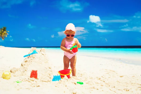 可愛い女の子が砂浜で遊ぶ — ストック写真