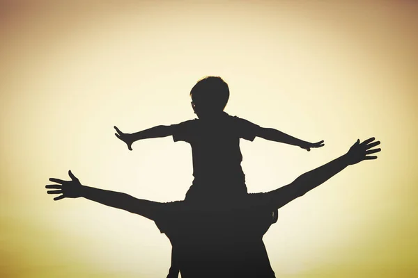 Father and son having fun at sunset — Stock Photo, Image