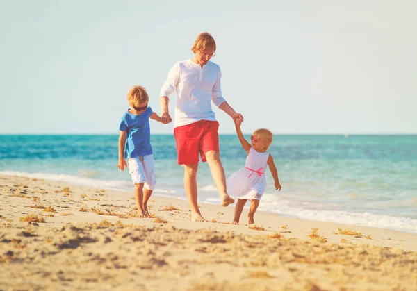 Vader en zoon en dochter spelen op strand — Stockfoto