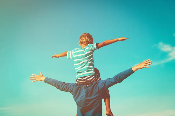 Father and son having fun on sky — Stock Photo, Image