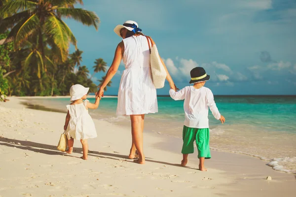 母亲带着小儿子和女儿走在海滩上 — 图库照片