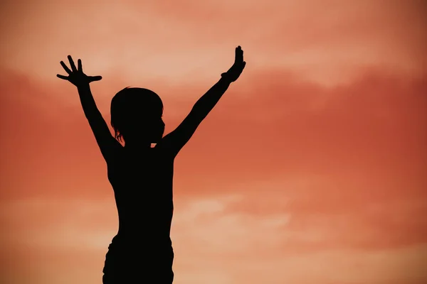 Silhouette of happy little boy at sunset sky — Stock Photo, Image