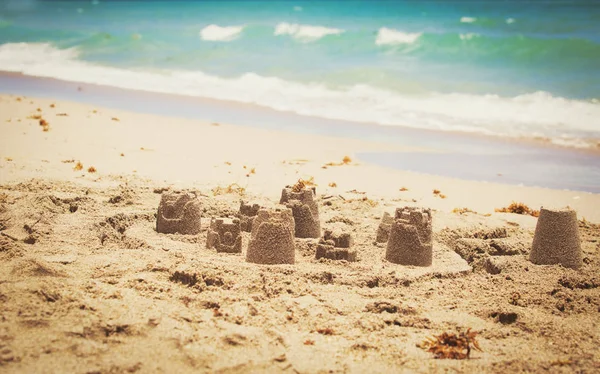 Castles from sand on beach — Stock Photo, Image