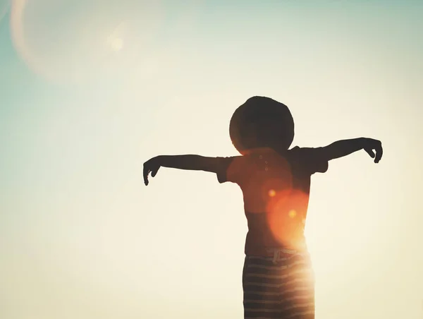 Silhouette of happy little boy at sky — Stock Photo, Image