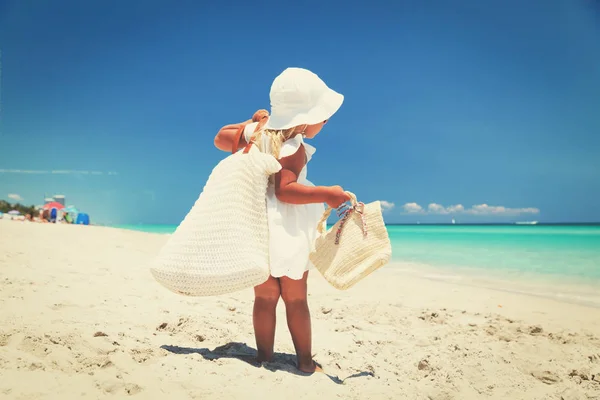 Let go to beach -little girl with bags at sea — стоковое фото