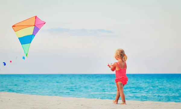 Malá holčička pouštění draka na pláži — Stock fotografie