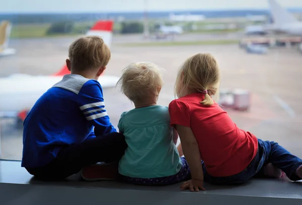 kids waiting for plane in airport