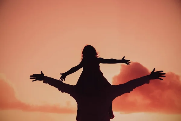 Father and little daughter silhouettes play at sunset — Stock Photo, Image