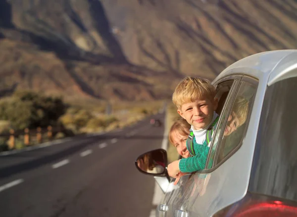 family travel by car-little boy with mother in mountains