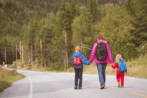 iki çocuk seyahat doğada yolda annesiyle