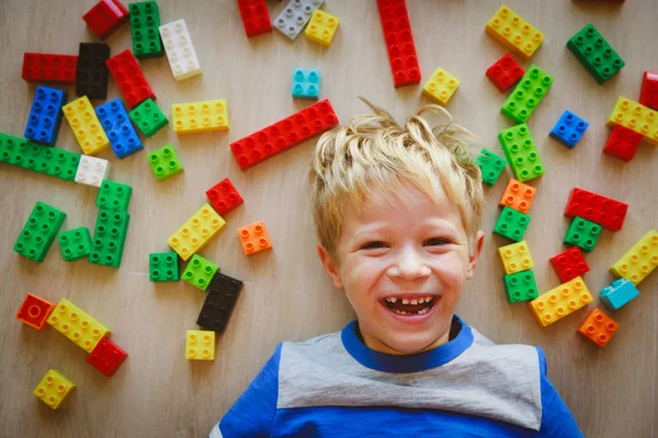 Happy cute little boy love playing with plastic blocks — Stock Photo, Image