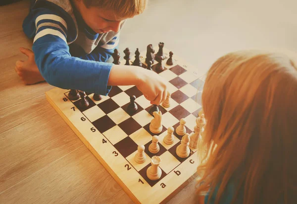 Little boy and girl play chess — Stock Photo, Image