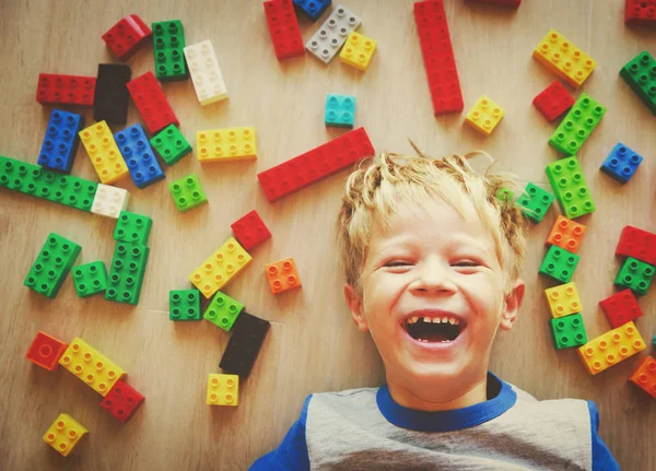 Happy cute little boy love playing with plastic blocks — Stock Photo, Image