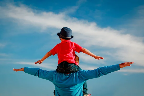 Father and son having fun on sky — Stock Photo, Image
