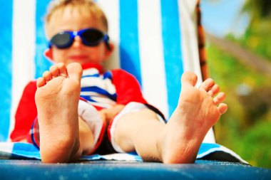 küçük çocuk sakin tropikal plajda, ayakları üzerinde odak