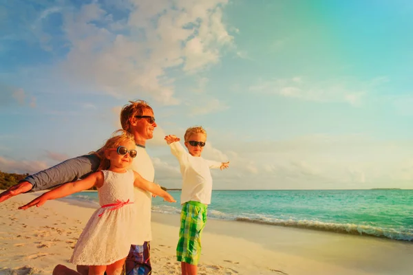 Baba ve iki çocuk tropikal plaj tatil keyfini çıkarın — Stok fotoğraf