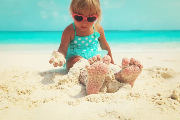 Holčička hrát s pískem na tropické pláži — Stock fotografie