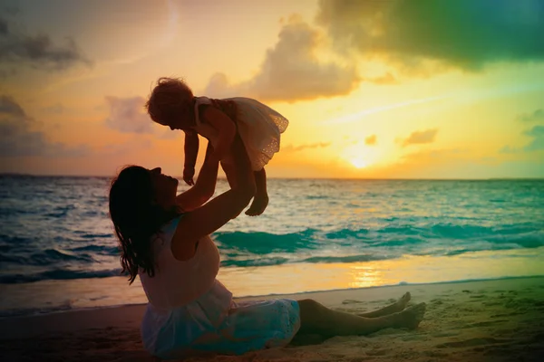 Mutter und kleine Tochter spielen bei Sonnenuntergang — Stockfoto