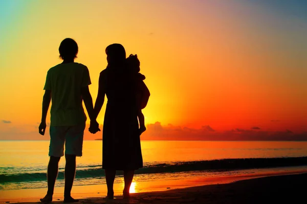 Happy romantic couple with small child on tropical beach — Stock Fotó