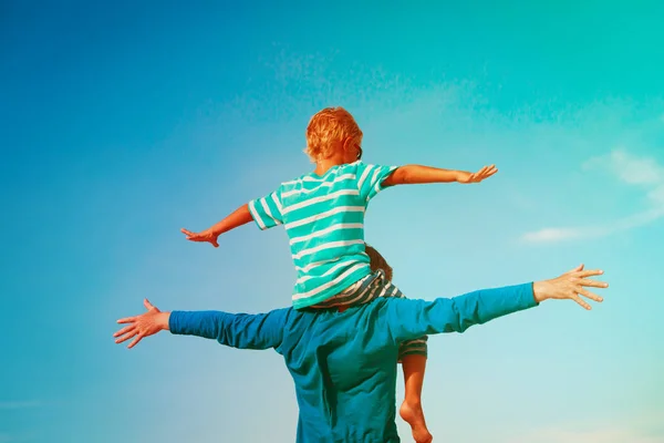 Father and son play having fun on sky — Stock Photo, Image