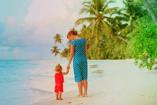 Madre e hija pequeña caminando en la playa —  Fotos de Stock