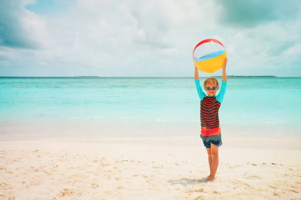 Niño feliz jugando pelota en la playa —  Fotos de Stock