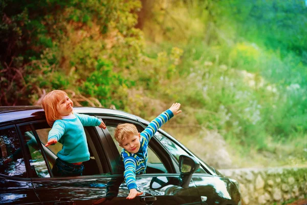 乘汽车旅行的快乐的小男孩和女孩 — 图库照片