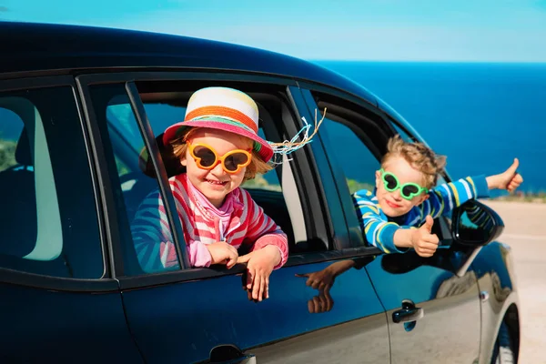 Happy little boy and girl enjoy travel by car at beach — Stock Photo, Image