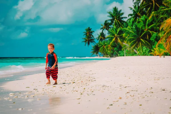 Gelukkig schattige kleine jongen draaien op tropisch strand — Stockfoto