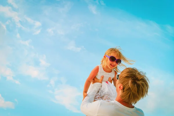 Far och liten dotter leker på himlen — Stockfoto