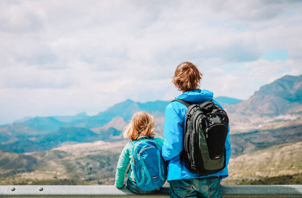 father and little daughter travel hiking in mountains