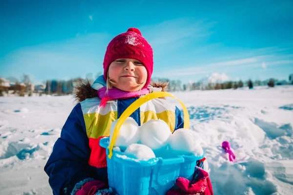 Little girl making snowball in winter nature — Stock Photo, Image